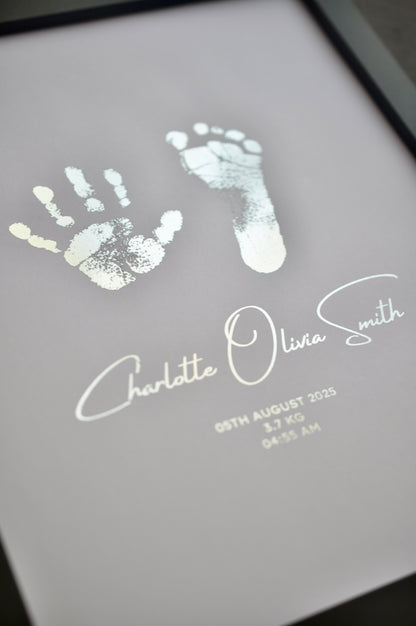 Hand and footprints with a name and date on a white background