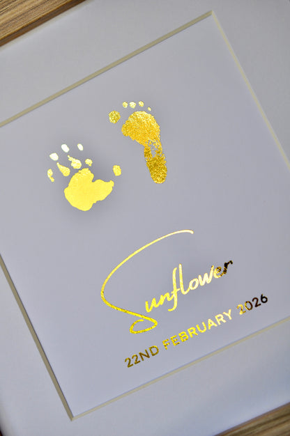 Framed paper with gold footprints and 'Sunflower' text on white background