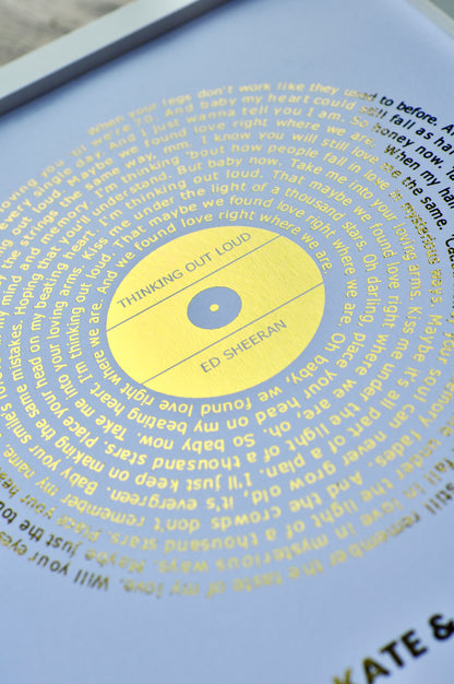 Song Lyrics printed in gold and on a white background