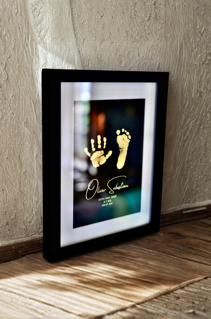 Framed artwork with hand and footprints on a textured wall.