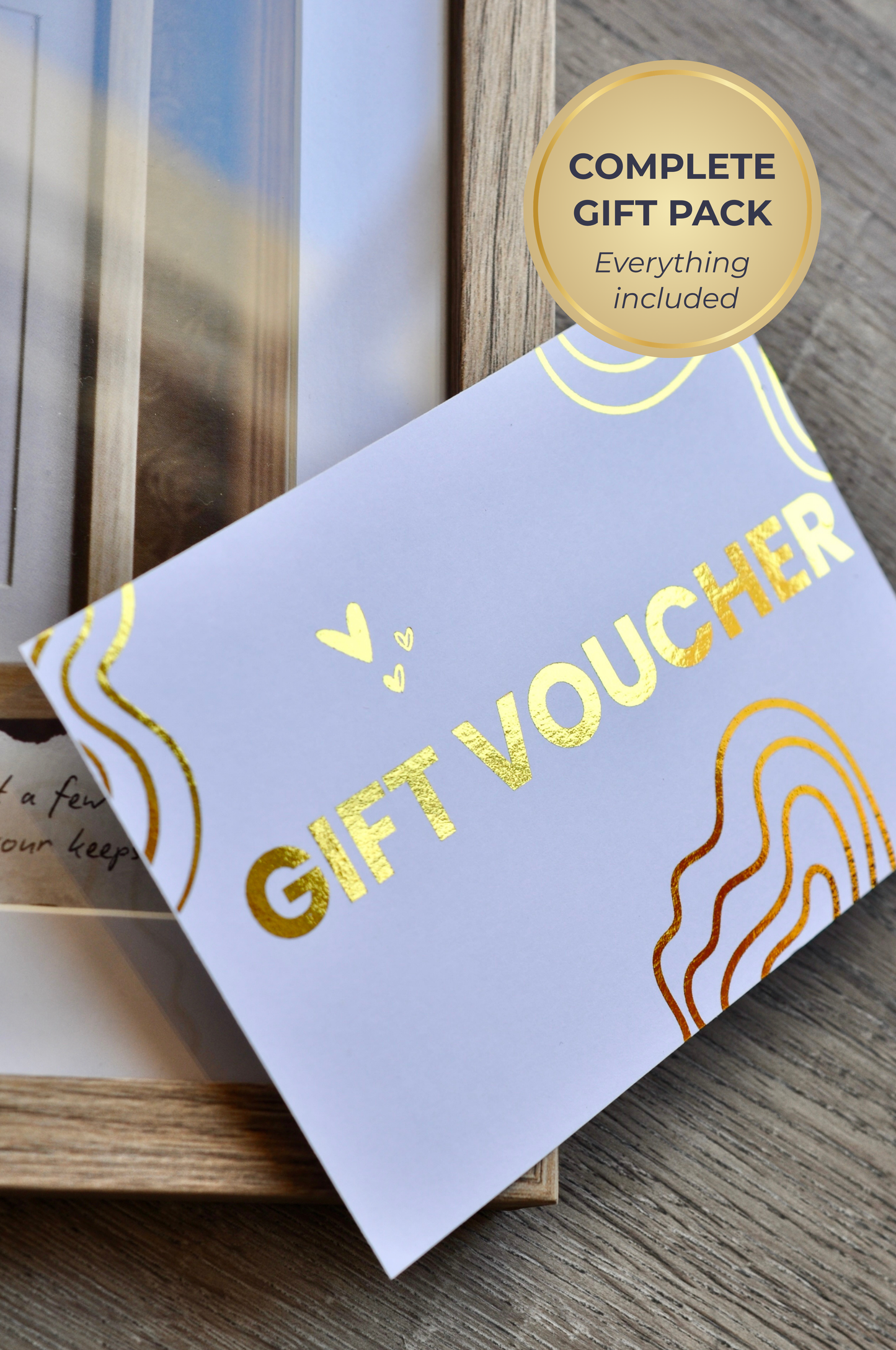 Gift voucher with gold text on a wooden surface