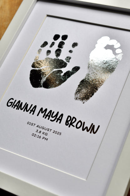 Framed print with hand and footprints and baby details on a white background