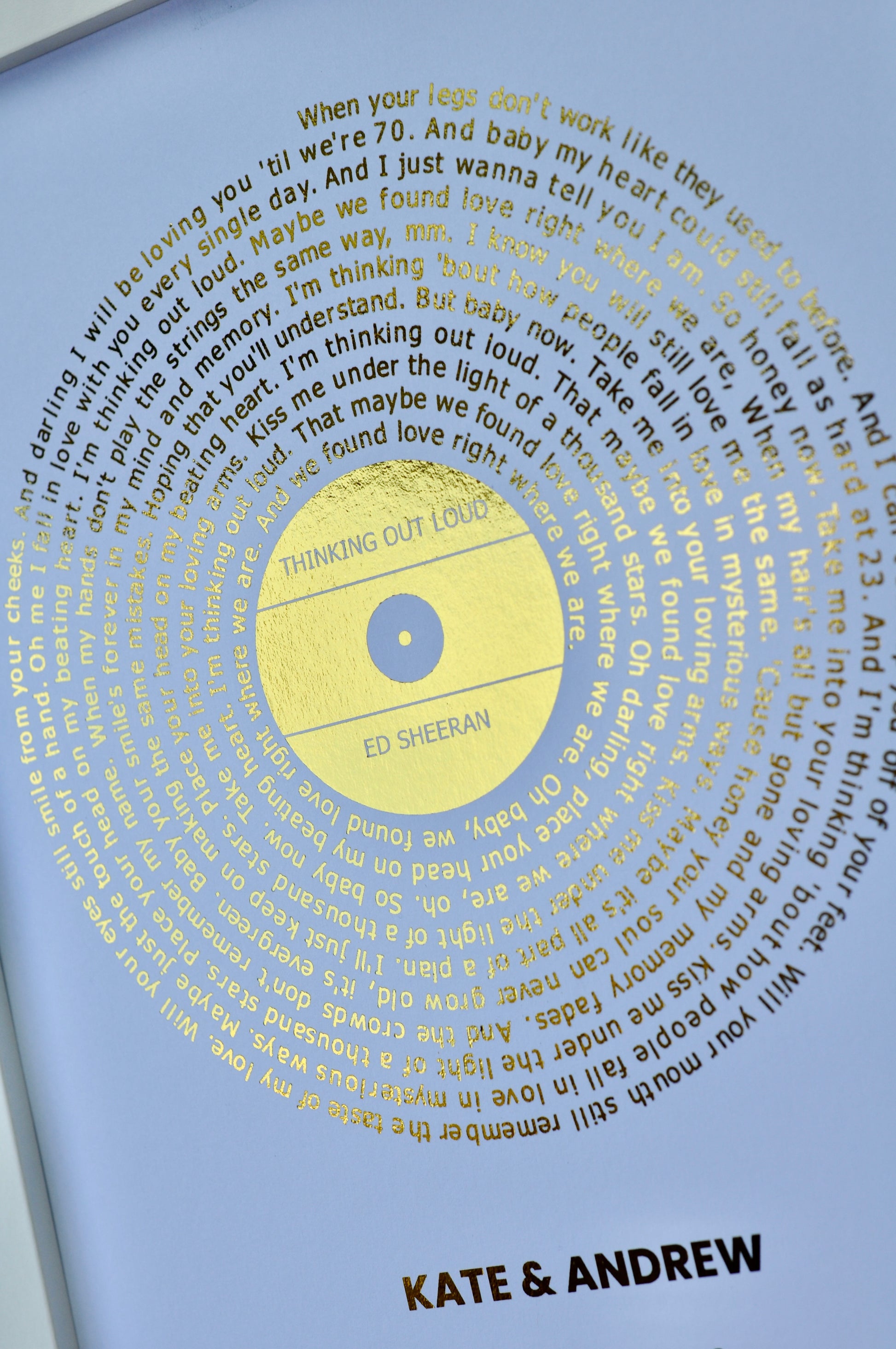 Personalized vinyl record with lyrics and names on a white background