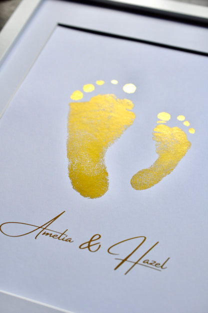 Gold footprints on a light blue card with 'Amelia & Hazel' text.