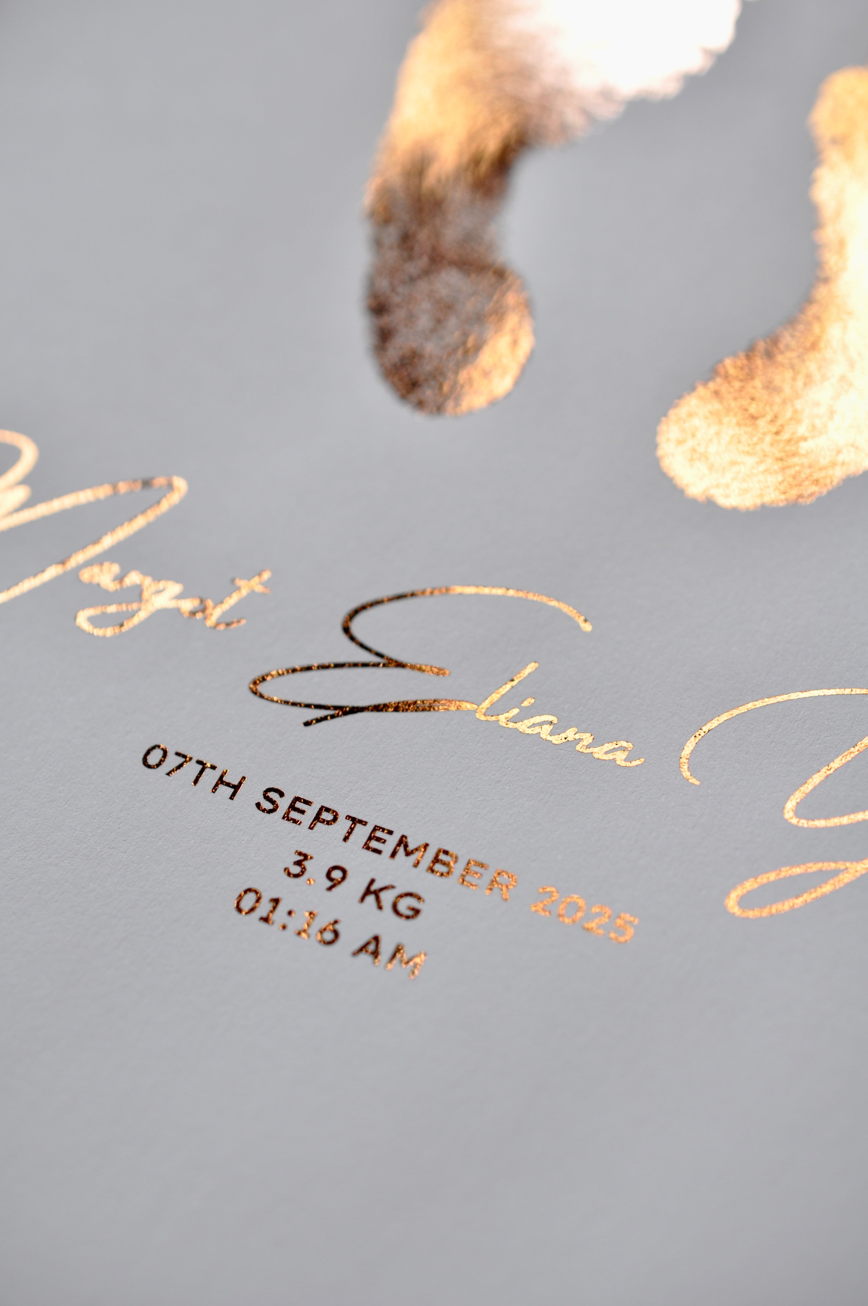 Baby keepsake with birth details in rose gold on a white background
